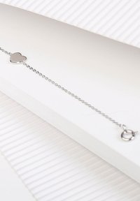 Silver chain bracelet featuring a small heart pendant, smooth finish, with a round clasp and an overall delicate design.