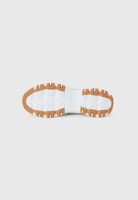 Baskets blanches avec une semelle en caoutchouc marron. Présente une surface texturée avec des rainures pour l'adhérence et un design de semelle intermédiaire rembourrée.