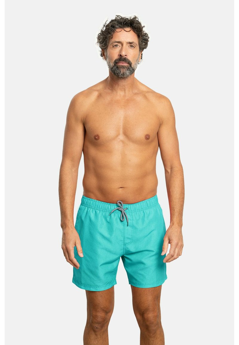 Bañadores turquesa con cintura elástica y cordón de ajuste, con una textura lisa y uniforme y un bolsillo delantero.