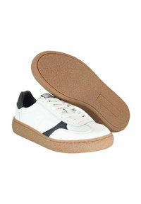 Sneaker bianchi in pelle con accento nero, dotati di una suola in sughero testurizzato e design con lacci. Superficie liscia con dettagli minimi.