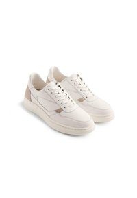 Sneakers bianchi in pelle con un accento in suede beige testurizzato sul tallone. Presentano lacci e una suola piatta in gomma con dettagli di cucitura minimi.