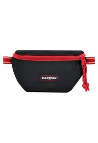 Czarny materiałowy woreczek z czerwonym zamkiem błyskawicznym i dodatkami, o zaokrąglonym kształcie, z naszywką z logo Eastpak z przodu, cechujący się mocnym przeszyciem i teksturowaną powierzchnią.