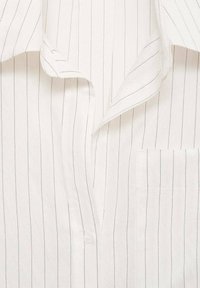 White striped button-up shirt, featuring thin dark stripes, a pocket on the left, and a soft, lightweight fabric with a collar.