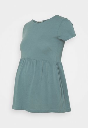 Haut de maternité manches courtes couleur sarcelle avec taille froncée et encolure ronde, présenté sur fond blanc.