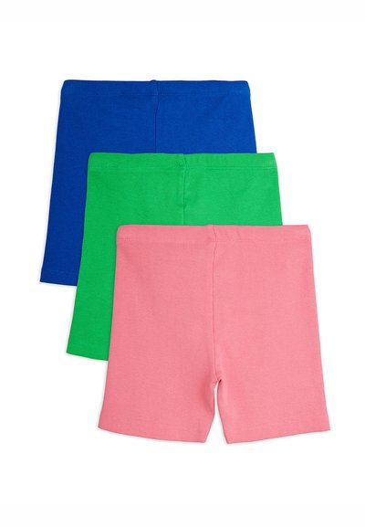 Trois paires de shorts tricotés côtelés unis en bleu, vert et rose, empilées verticalement sur un fond blanc.