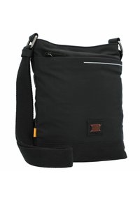 Sort stofpose med skulderrem, der har en frontlomme med lynlås, en brun logo-patch og en refleksbånd øverst.