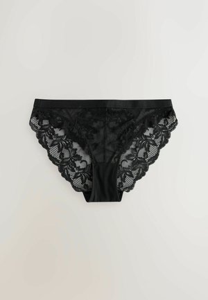 Svarta spetsunderkläder med vågig kant, blommönster och en smidig midja. Tillverkade av ett genomskinligt material med intrikata detaljer.