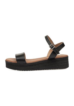 Sandalias de cuña negras con parte superior de cuero texturizado, punta abierta y tira en el tobillo con hebilla plateada. Plantilla acolchada con una suela gruesa.