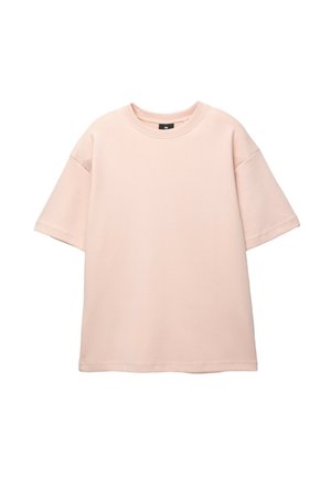 Tricou oversized de culoare roz deschis, din bumbac, cu mâneci scurte și decolteu rotund, având o textură netedă și simplă, fără modele.