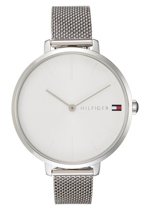 Minimalistische Armbanduhr in Silber-Ton mit Mesh-Armband, weißem Zifferblatt, ohne Zahlen, schlanken Zeigern und Tommy Hilfiger-Logo mit Flagge bei 3 Uhr.