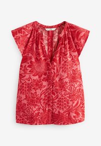 Haut court à manches courtes rouge à fleurs, avec un col en V, un tissu texturé et une fermeture à boutons. Le design comprend des motifs intriqués de fleurs et de fruits.