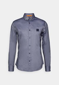 Long-sleeve button-up shirt in dark blue textured fabric, featuring a contrasting orange collar lining and a small logo patch on the chest.