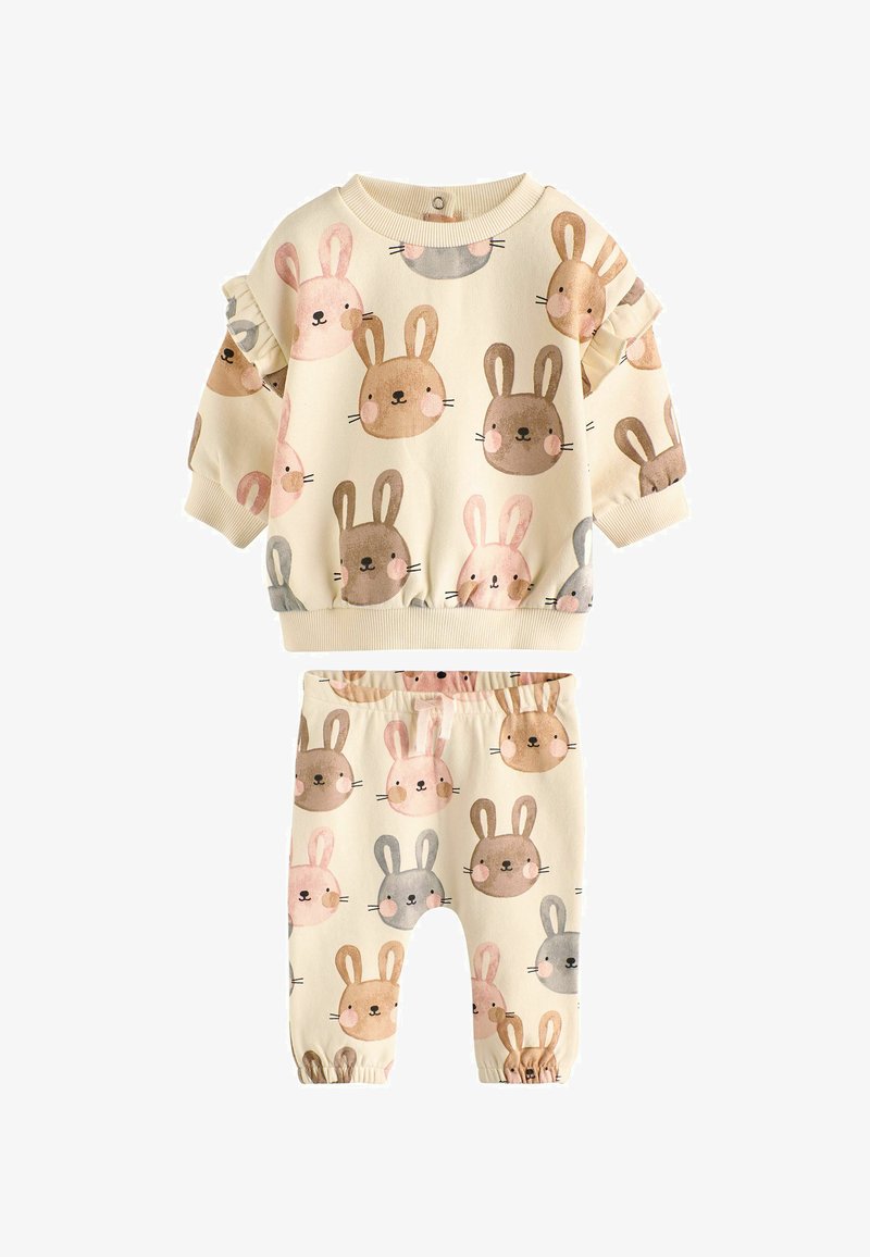 Ensemble crème pour tout-petit avec manches longues et pantalon, décoré de jolis visages de lapin en rose, marron, gris et beige.