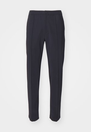 Navy trousers featuring a tailored design, flat front, and two front pleats. Made of smooth fabric with a standard waistband and button closure.
