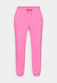 Pink sweatpants made of soft cotton blend, featuring a drawstring waist, ribbed cuffs, and small logo printed on the thigh.