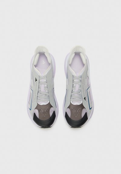 Light purple and gray athletic shoes with a mesh upper, black rubber sole, and geometric accents. Features textured panels and laces.