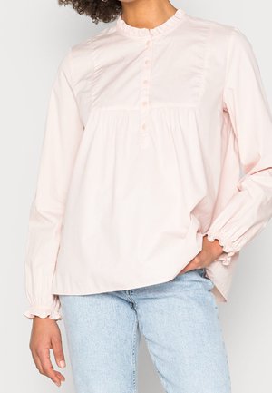 Helles rosa, langärmliges Blusenshirt aus weichem Stoff mit rüschigem Ausschnitt, Knopfverschluss vorne und gerafftem Bund. Mit Manschettenärmel. Lässiger Schnitt.