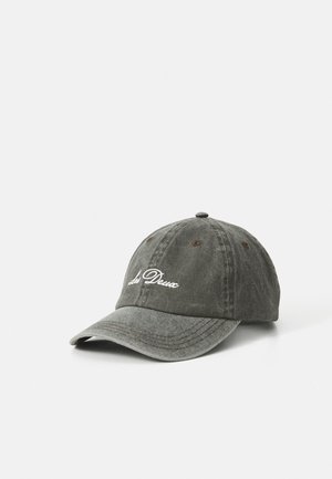 Worn dark gray baseball cap with white "Les Deux" script on front, stitched eyelets, and curved brim on white background.