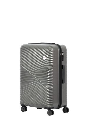 Hard-shell gray suitcase with wavy texture, four black wheels, top handle, and zipper closure. Features a small circular logo on the front.