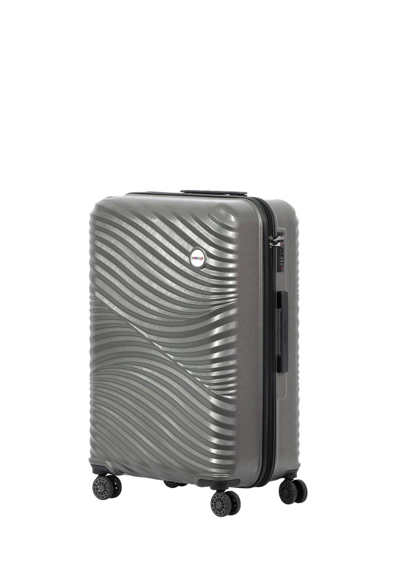 Hard-shell gray suitcase with wavy texture, four black wheels, top handle, and zipper closure. Features a small circular logo on the front.