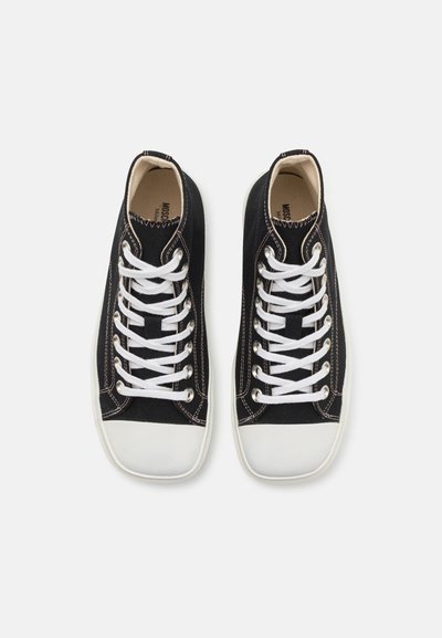 High-top canvas sneakers in black with white laces and rubber soles. Features include contrast stitching and a rounded toe design.