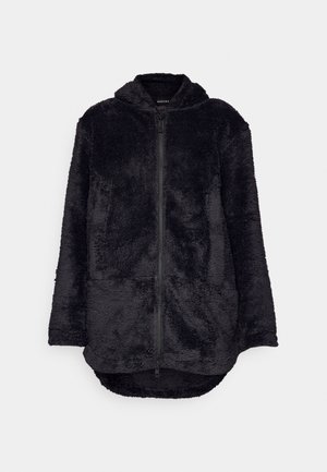 Black fleece jacket with a zip front, hood, and two front pockets. Features a soft, textured surface and an elongated back hem.
