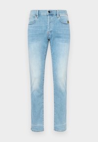 Jean en denim bleu clair coupe slim, style cinq poches, fermeture par boutons et délavage subtil aux cuisses et genoux.