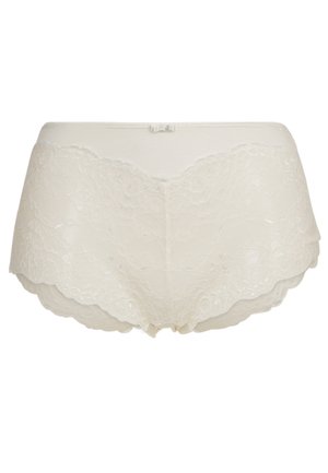 Beige kanten slip met geschulpte randen, voorzien van een zachte textuur en een naadloos ontwerp. Inclusief een kleine strikaccent bij de taille.