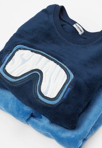 Navy blue plush sweatshirt with a ski goggles design in white and light blue embroidery. Soft texture, round neckline, and layered look.