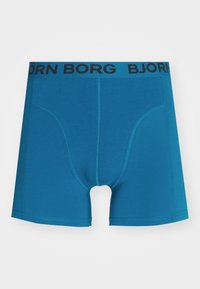 Boxer shorts blu in cotone con vita elastica nera su cui è stampato "BJÖRN BORG" in lettere maiuscole. Texture liscia e design aderente.