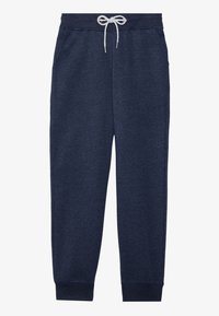 Pantalones deportivos azul marino hechos de un tejido suave y texturizado, con un cordón blanco, bolsillos laterales y puños ajustados en los tobillos.