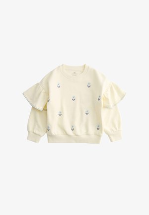 Kremfarvet børnesweater med lange ærmer med lille blå blomst broderi og flæsedetaljer på de øverste ærmer.
