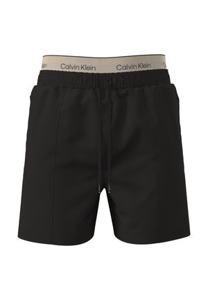 Zwarte herenshorts met elastische tailleband en verstelbare trekkoord, met zichtbare beige Calvin Klein merkbare binnenband.