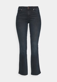 Mörk tvättade utsvängda jeans i denim, med hög midja, framfickor och subtila sömmar. Sömmen är något fransig.