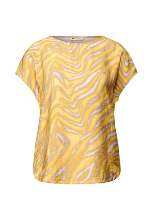 Top jaune présentant un motif zèbre ondulé en gris et blanc. Manches courtes, encolure ronde et tissu léger et textur é.