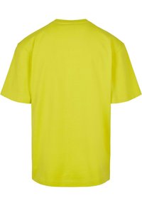 Krátký rukáv triko jasně žluté barvy, z bavlny, s klasickým výstřihem, jednoduchý design, jednobarevné, bez viditelných vzorů nebo akcentů.