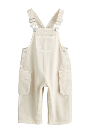 Beżowe ogrodniczki dla malucha z regulowanymi szelkami, przednią kieszenią na piersi i dużymi kieszeniami z klapami po obu stronach.
