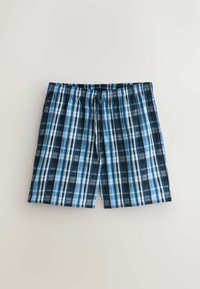 Shorts en coton à carreaux bleus et noirs avec taille élastique et cordon à l'avant sur un fond gris clair.