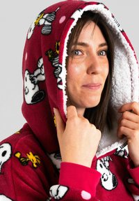Red fleece hooded sweatshirt featuring Snoopy and Woodstock graphics, lined with white fluffy material, with pink polka dots as accents.