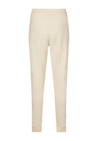 Beige katoenen joggers met een taps toelopend ontwerp, elastische tailleband en ribgebreide boorden. Terwijl textuur en minimale details.