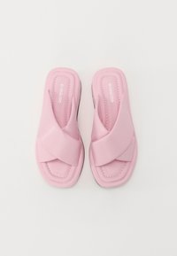Rosa kross-rem sandal med mykt materiale, med polstret fotseng, firkantet tå og kontrastsøm på en svart såle.