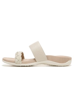 White leather slide sandal with a textured strap, braided detail, and soft beige footbed. Flexible sole with a textured bottom for grip.