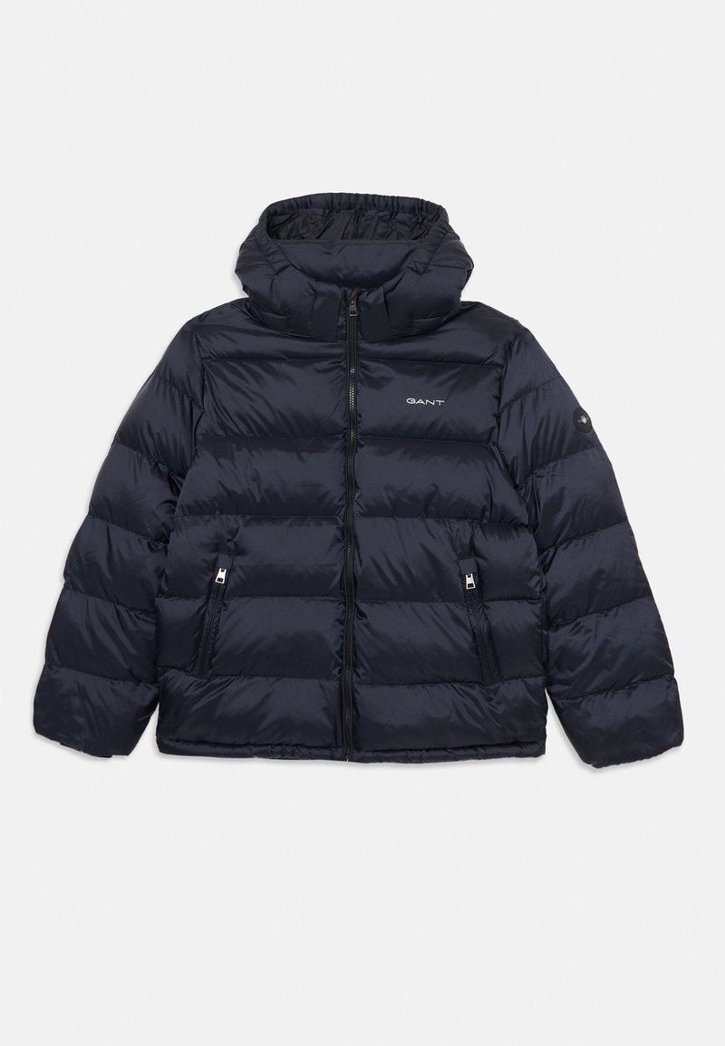 Navy blue puffer jacket with a high collar, zipper front, and two side pockets. Features a textured, quilted design with gray accents.