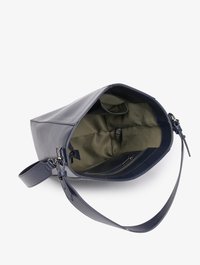 Bolso de cuero azul oscuro con correa ajustable y interior de tela verde oliva, que cuenta con un bolsillo interior con cremallera.