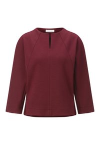 Burgundi tooni top, ümmarguse kaelusega, kolmeveerandi pikkustes varrukates, ees võtmekoht ja küljetaskud. Sujuv, tekstuuriga kangas koos õmbluste detailidega.