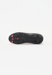 Black footwear with a textured sole, featuring red studs for traction. The design is low-profile with a smooth finish and subtle branding detail.