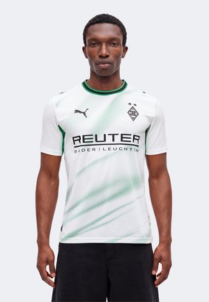 Homme portant le maillot de football blanc et vert du Borussia Mönchengladbach avec le logo Puma et le texte du sponsor "REUTER BÄDER | LEUCHTEN".