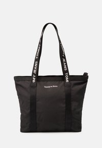 Sac fourre-tout noir en tissu durable, avec des poignées noires doubles et un logo de marque blanc accompagné de texte signature imprimé le long des sangles.
