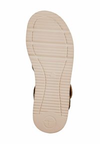 Platt, beige gummisula med horisontella spår och en cirkulär logotyp. Storlek 37 angiven. Slät textur med enhetlig färg genom hela sulan.