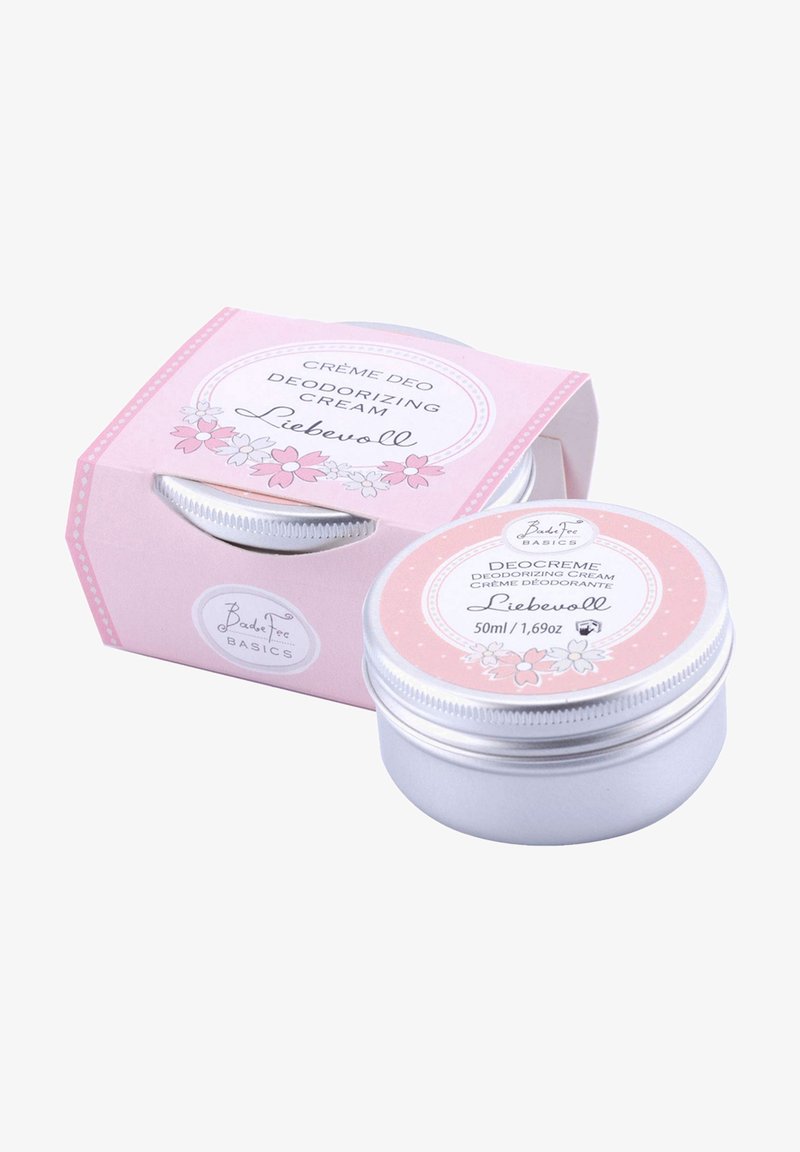 Deodorizing cream in a silver tin with a pink floral label, packaged in a pink box. 50ml, featuring round shapes and smooth textures.